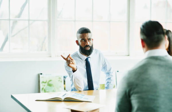 businessman-asking-a-question-during-client-meeting-in-office-conference-room